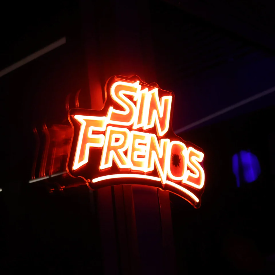 The Sin Frenos neon sign, lit red